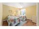 Bright bedroom with two twin beds and wood flooring at 1521 Trenton Ln, The Villages, FL 32162