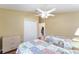 Bedroom with two beds, ceiling fan, and wood floors at 1521 Trenton Ln, The Villages, FL 32162