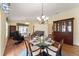 Bright dining room features a glass table, chandelier, and built-in hutch at 1521 Trenton Ln, The Villages, FL 32162