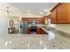 Kitchen with granite countertops, stainless steel appliances and hardwood floors at 1521 Trenton Ln, The Villages, FL 32162