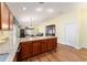 Granite kitchen island with hardwood floors and wood cabinets at 1521 Trenton Ln, The Villages, FL 32162