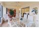 Relaxing screened porch with seating area and glass top table at 1521 Trenton Ln, The Villages, FL 32162