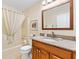 Bathroom with granite vanity, shower, and updated fixtures at 1526 Lozano Ave, Lady Lake, FL 32159