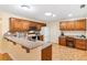 Galley-style kitchen with granite counters and wood cabinetry at 1526 Lozano Ave, Lady Lake, FL 32159