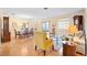 Living room with hardwood floors, a yellow armchair and a glass coffee table at 1526 Lozano Ave, Lady Lake, FL 32159