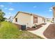 Neat side yard with a path and landscaping, AC unit visible at 1526 Lozano Ave, Lady Lake, FL 32159