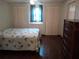 Main bedroom with double bed and wood laminate flooring at 164 Jacaranda Dr, Leesburg, FL 34748