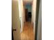 Clean hallway with light wood flooring and access to bathroom at 164 Jacaranda Dr, Leesburg, FL 34748