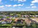 Aerial view showing neighborhood homes, golf course, and pool at 1712 Palo Alto Ave, Lady Lake, FL 32159