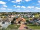 Aerial view of single-Gathering home with red tile roof and large backyard at 1712 Palo Alto Ave, The Villages, FL 32159