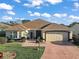 One-story home with a tile roof, attached garage, and landscaped lawn at 1712 Palo Alto Ave, Lady Lake, FL 32159