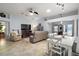 Living room featuring a large sectional sofa, flat screen TV, and fireplace at 1712 Palo Alto Ave, The Villages, FL 32159