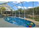 Relaxing screened-in pool with surrounding lush greenery at 1712 Palo Alto Ave, The Villages, FL 32159