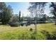 Peaceful backyard oasis with a pond and lush landscaping at 17120 Cypresswood Way, Clermont, FL 34714