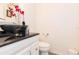 Stylish bathroom with vessel sink, dark countertop, and modern fixtures at 17120 Cypresswood Way, Clermont, FL 34714