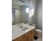 Simple bathroom with shower/tub combo and wood vanity at 1735 Southern Oak Loop, Minneola, FL 34715