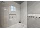 Bathroom with a tub and shower, and glass block window at 17640 Las Brisas Ct, Winter Garden, FL 34787