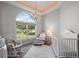 Bright Bedroom featuring a crib, glider, and large window at 17640 Las Brisas Ct, Winter Garden, FL 34787