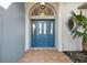 Inviting entryway with a stylish blue door and arched window detail at 17640 Las Brisas Ct, Winter Garden, FL 34787