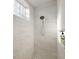 Clean shower with marble tile and glass block window at 17640 Las Brisas Ct, Winter Garden, FL 34787