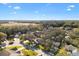 Aerial view of a residential neighborhood with mature trees and houses at 208 Desota Ct, The Villages, FL 32159