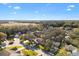 Aerial view of a residential neighborhood with mature trees and houses at 208 Desota Ct, The Villages, FL 32159