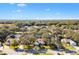 Aerial view of a residential neighborhood with mature trees and houses at 208 Desota Ct, The Villages, FL 32159