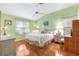 Bright bedroom with king-size bed, wood floors, and a ceiling fan at 208 Desota Ct, The Villages, FL 32159