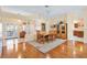 Bright dining room with hardwood floors, wood furniture, and kitchen view at 208 Desota Ct, The Villages, FL 32159