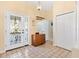 Bright entryway with tile floors, coat closet, and view to living room at 208 Desota Ct, The Villages, FL 32159