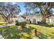 Cute yellow house with a 2-car garage and nicely landscaped lawn at 208 Desota Ct, The Villages, FL 32159