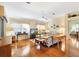 Bright living room with hardwood floors, comfy sofas, and lots of natural light at 208 Desota Ct, The Villages, FL 32159