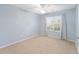 Spacious bedroom with light blue walls and carpet flooring at 2123 Barbosa Ct, The Villages, FL 32159