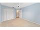 Light blue bedroom with double door closet and bathroom access at 2123 Barbosa Ct, The Villages, FL 32159