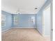 Bright bedroom with light blue walls and neutral carpeting at 2123 Barbosa Ct, The Villages, FL 32159