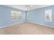 Spacious bedroom with light blue walls and neutral carpeting at 2123 Barbosa Ct, The Villages, FL 32159