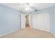 Light blue bedroom featuring a double door closet and bathroom access at 2123 Barbosa Ct, The Villages, FL 32159