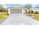 Two-car garage with a screened enclosure and a flagstone driveway at 2123 Barbosa Ct, The Villages, FL 32159