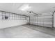 Spacious garage with epoxy flooring and overhead storage at 2123 Barbosa Ct, The Villages, FL 32159