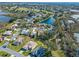 Aerial view of a single Gathering home near a pond at 21509 Castle View Ct, Leesburg, FL 34748