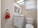 Simple bathroom with white vanity, toilet, and a single sink at 21509 Castle View Ct, Leesburg, FL 34748