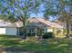 House exterior showcases a large backyard, screened porch, and mature trees at 21509 Castle View Ct, Leesburg, FL 34748