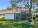 Charming single-story house features a screened porch and lush lawn at 21509 Castle View Ct, Leesburg, FL 34748