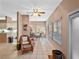 Bright sunroom with wicker chair and view of backyard at 21509 Castle View Ct, Leesburg, FL 34748