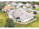 Aerial view showcasing home's roofline and landscaping at 21721 Loch Haven Pass, Leesburg, FL 34748