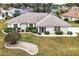 Single-story home with landscaped yard and driveway, viewed from above at 21721 Loch Haven Pass, Leesburg, FL 34748