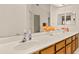 Bathroom featuring dual sinks, granite counters, and a large mirror at 21721 Loch Haven Pass, Leesburg, FL 34748