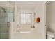 Relaxing bathroom features a soaking tub, glass-enclosed shower, and neutral decor at 21721 Loch Haven Pass, Leesburg, FL 34748