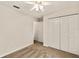 Neutral bedroom features a ceiling fan, closet, and a glimpse into other rooms at 21721 Loch Haven Pass, Leesburg, FL 34748