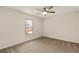 Cozy bedroom with plush carpeting, a ceiling fan, and a window with natural light at 21721 Loch Haven Pass, Leesburg, FL 34748